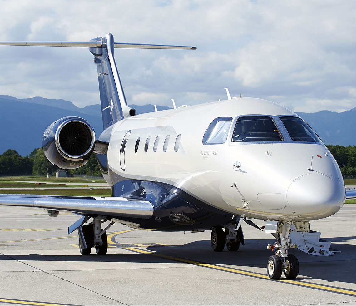 Embraer Legacy 450 private jet on runway during day